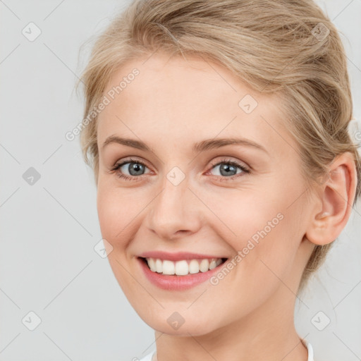 Joyful white young-adult female with medium  brown hair and blue eyes