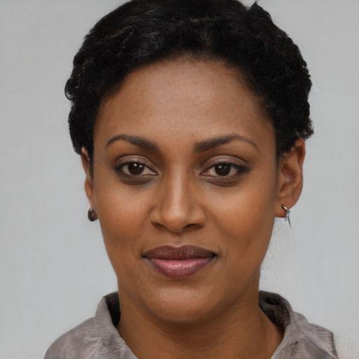 Joyful latino young-adult female with short  black hair and brown eyes