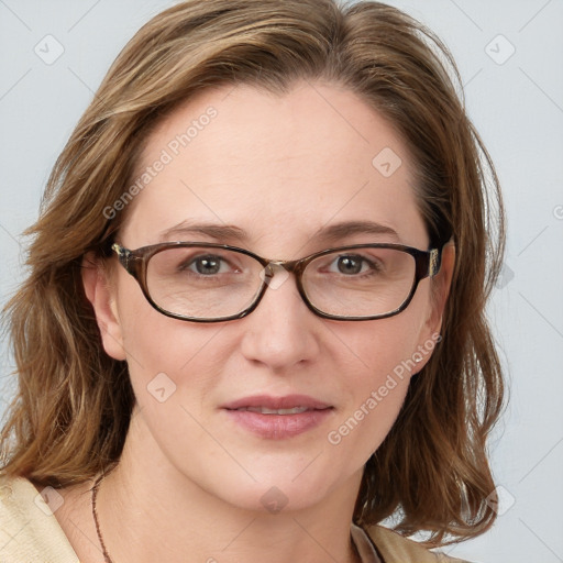 Joyful white adult female with medium  brown hair and blue eyes