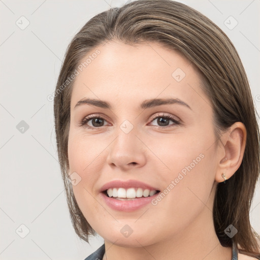 Joyful white young-adult female with medium  brown hair and grey eyes