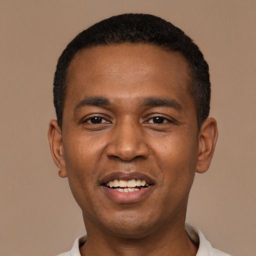Joyful black young-adult male with short  black hair and brown eyes