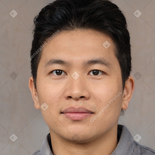 Joyful asian young-adult male with short  brown hair and brown eyes