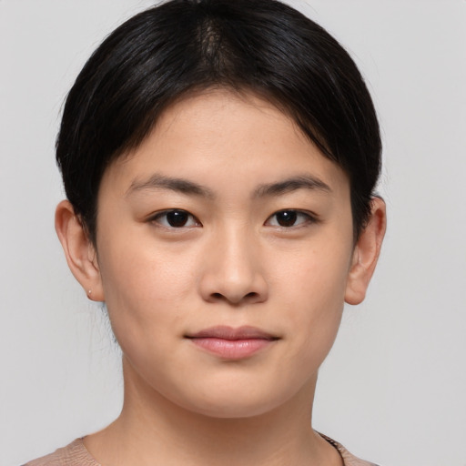 Joyful asian young-adult female with short  brown hair and brown eyes
