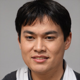 Joyful asian young-adult male with short  black hair and brown eyes