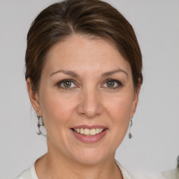 Joyful white adult female with short  brown hair and grey eyes