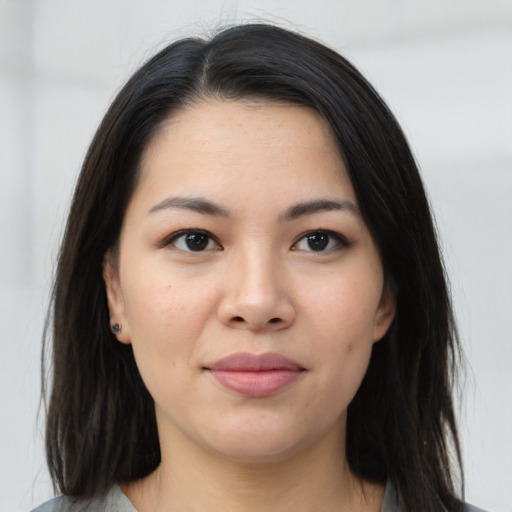 Joyful asian young-adult female with long  brown hair and brown eyes