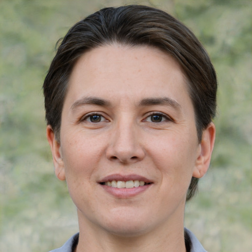 Joyful white adult female with short  brown hair and brown eyes