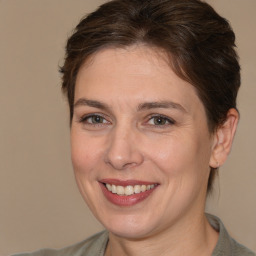 Joyful white adult female with medium  brown hair and brown eyes