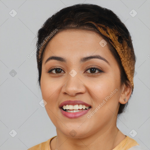 Joyful latino young-adult female with medium  brown hair and brown eyes