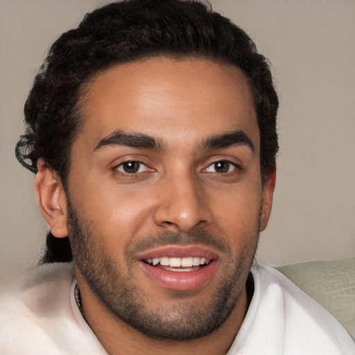 Joyful latino young-adult male with short  brown hair and brown eyes