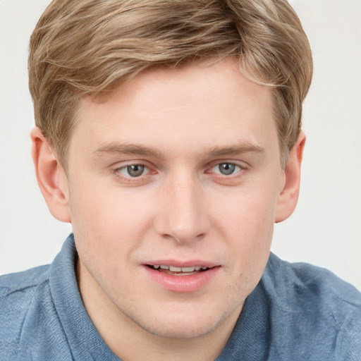 Joyful white young-adult male with short  brown hair and blue eyes