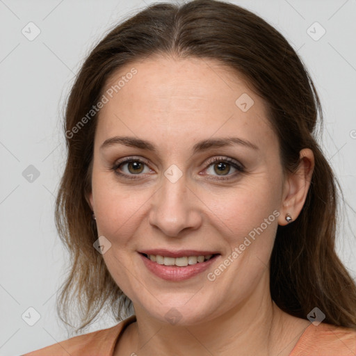 Joyful white adult female with medium  brown hair and grey eyes