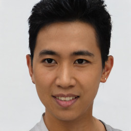 Joyful asian young-adult male with short  black hair and brown eyes