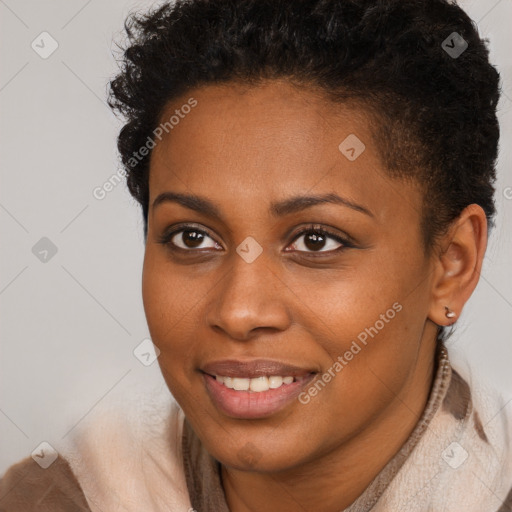 Joyful black young-adult female with short  brown hair and brown eyes