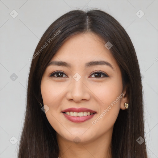 Joyful latino young-adult female with long  brown hair and brown eyes