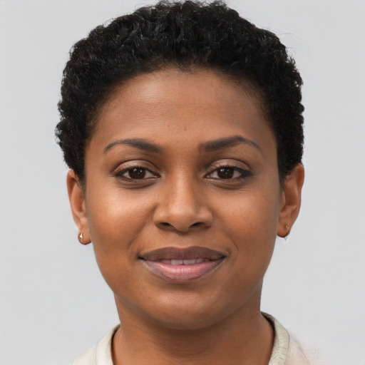 Joyful black young-adult female with short  brown hair and brown eyes