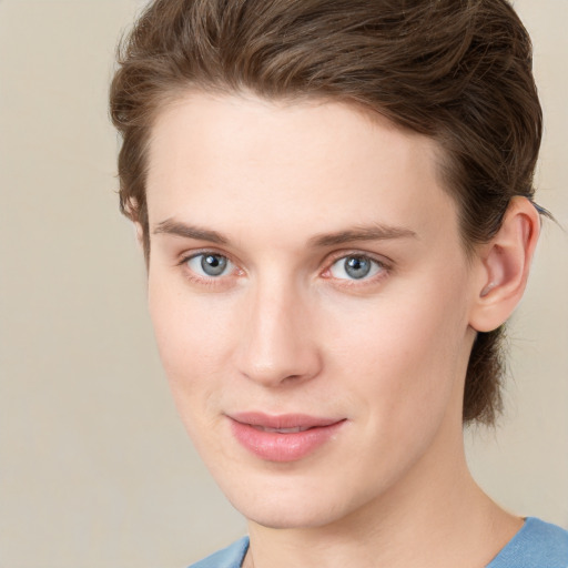 Joyful white young-adult female with short  brown hair and grey eyes