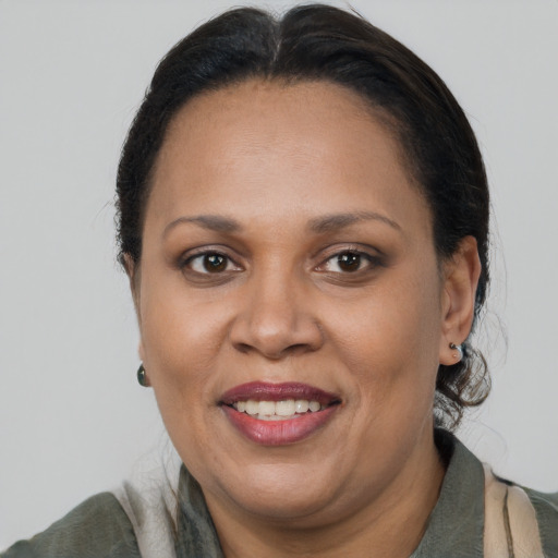 Joyful latino adult female with long  brown hair and brown eyes