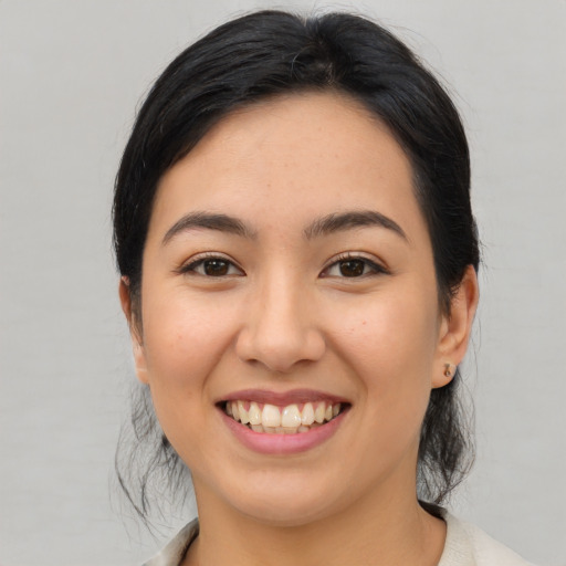 Joyful asian young-adult female with medium  brown hair and brown eyes