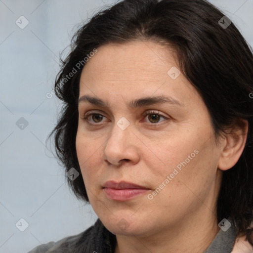 Joyful white adult female with medium  brown hair and brown eyes