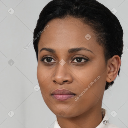 Joyful black young-adult female with short  brown hair and brown eyes