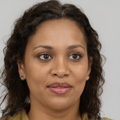 Joyful black adult female with medium  brown hair and brown eyes