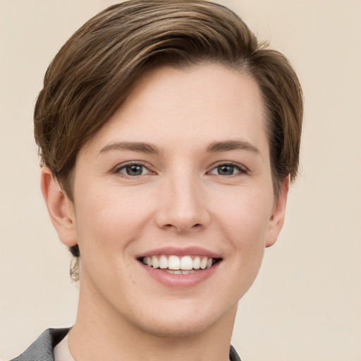 Joyful white young-adult female with short  brown hair and grey eyes