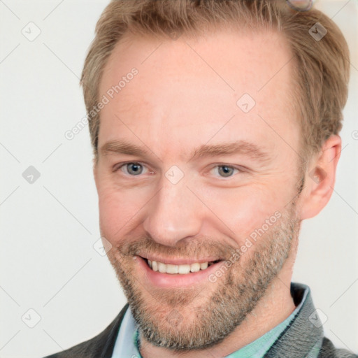 Joyful white adult male with short  brown hair and grey eyes