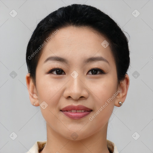 Joyful asian young-adult female with short  black hair and brown eyes