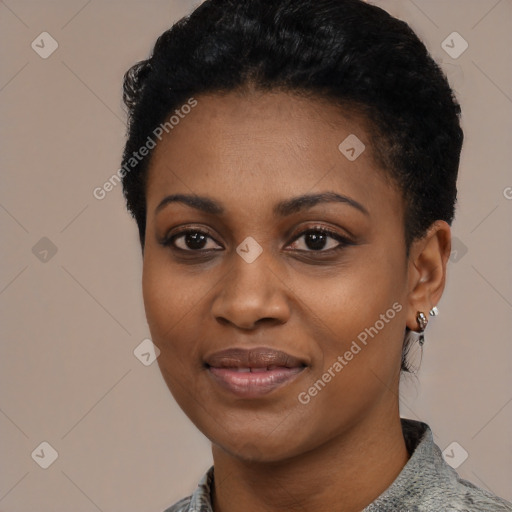 Joyful black young-adult female with short  black hair and brown eyes