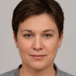 Joyful white adult female with short  brown hair and grey eyes