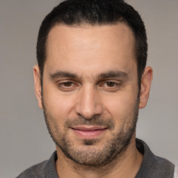 Joyful white adult male with short  brown hair and brown eyes