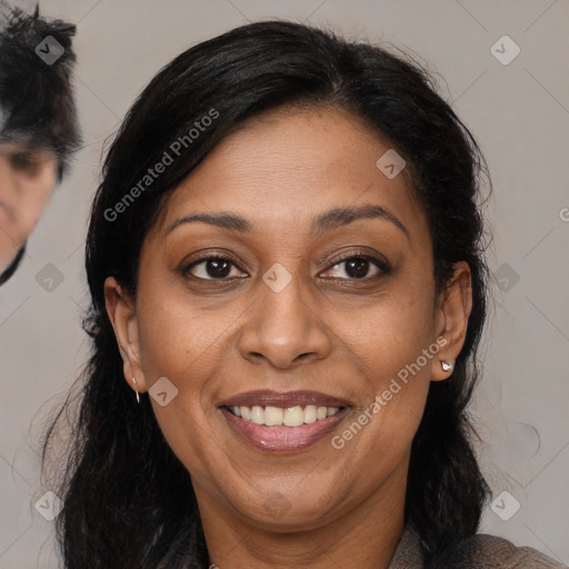 Joyful latino adult female with medium  brown hair and brown eyes