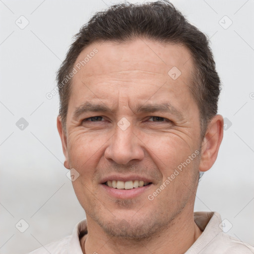 Joyful white adult male with short  brown hair and brown eyes