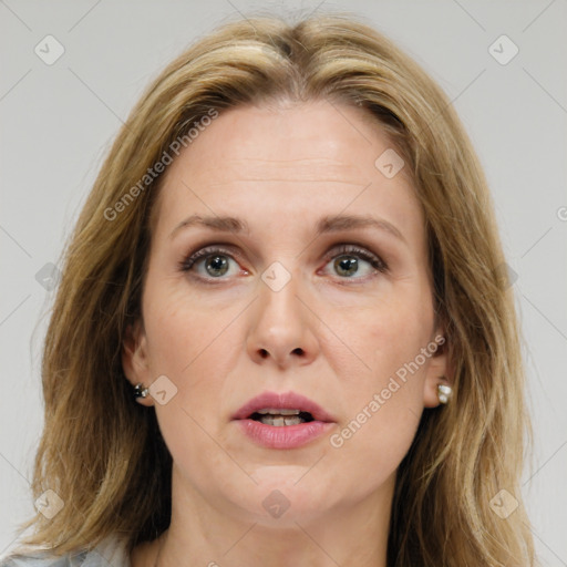 Joyful white adult female with medium  brown hair and green eyes