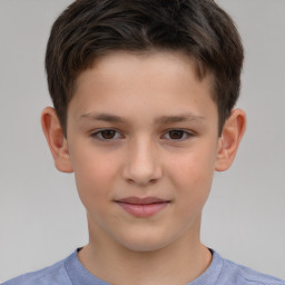 Joyful white child male with short  brown hair and brown eyes