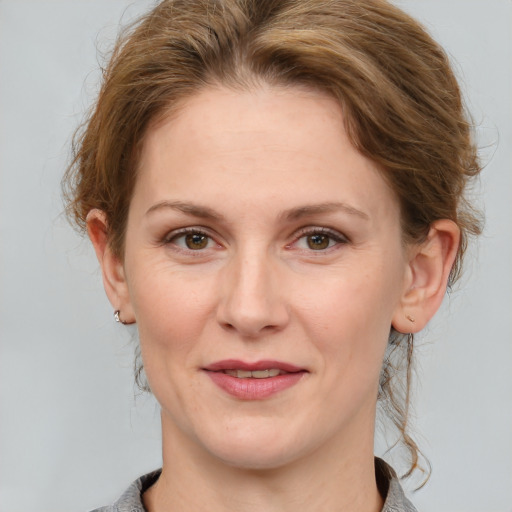 Joyful white adult female with medium  brown hair and grey eyes