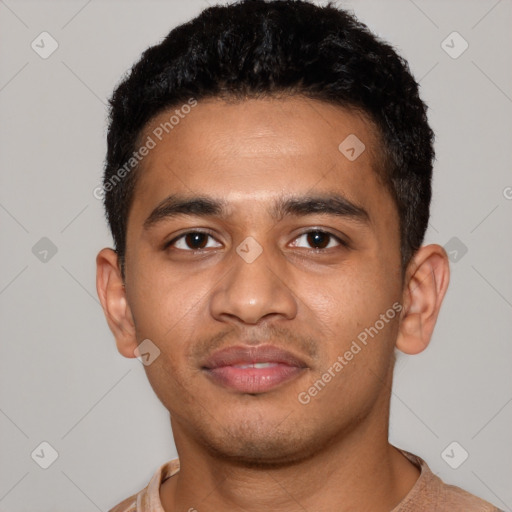 Joyful latino young-adult male with short  black hair and brown eyes