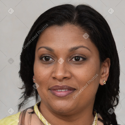 Joyful latino adult female with medium  brown hair and brown eyes