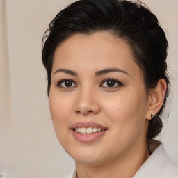 Joyful latino young-adult female with medium  brown hair and brown eyes