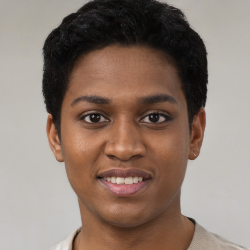 Joyful black young-adult female with short  black hair and brown eyes