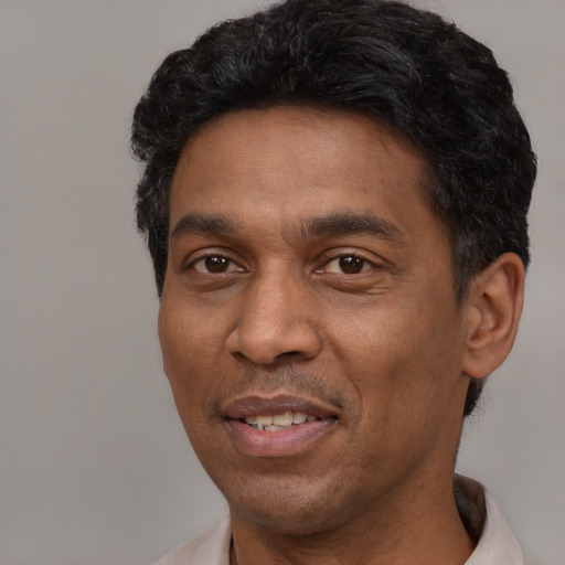 Joyful latino adult male with short  black hair and brown eyes