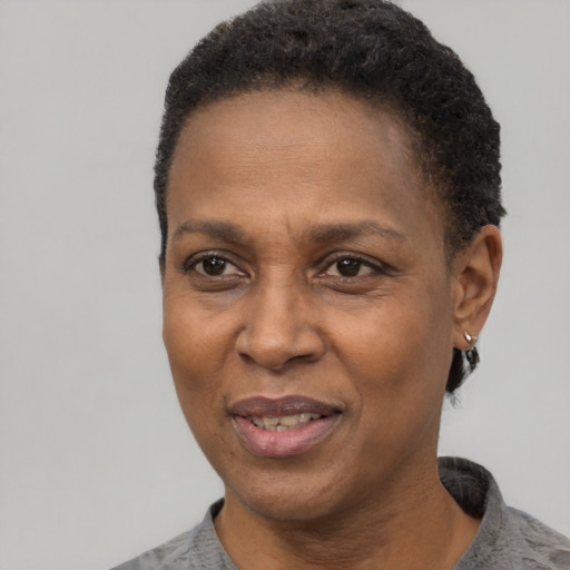 Joyful black adult female with short  black hair and brown eyes