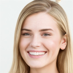 Joyful white young-adult female with long  brown hair and blue eyes