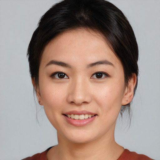 Joyful asian young-adult female with medium  black hair and brown eyes