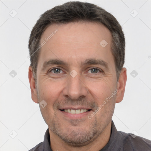 Joyful white adult male with short  brown hair and brown eyes