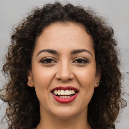 Joyful white young-adult female with long  brown hair and brown eyes