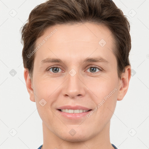 Joyful white young-adult male with short  brown hair and grey eyes