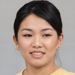 Joyful asian young-adult female with short  black hair and brown eyes