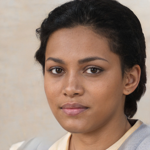 Joyful latino young-adult female with short  brown hair and brown eyes